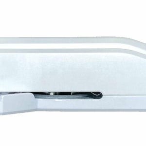 A white stapler with a metal staple head.