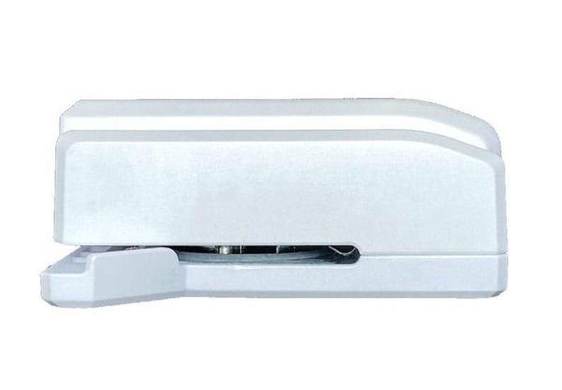 A white stapler with a metal staple head.