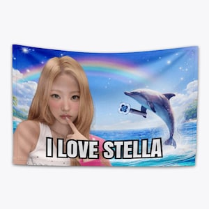 May include: A wall tapestry featuring a woman with blonde hair and the text "I LOVE STELLA". The background includes a dolphin jumping out of the ocean, a rainbow, and a blue sky with clouds.