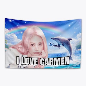 May include: A wall tapestry featuring a woman with pink hair, a dolphin, and a rainbow against a blue sky. The text "I LOVE CARMEN" is displayed in bold, white letters.