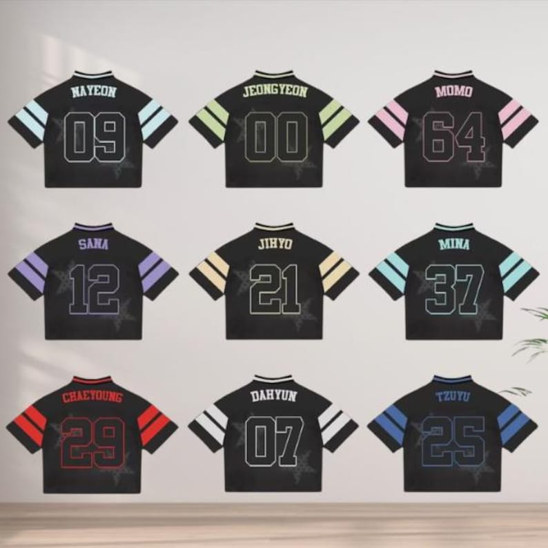 May include: Nine black crop tops with different names and numbers. Each top has a different color scheme on the sleeves and the name and number on the back. The names include NAYEON, JEONGYEON, MOMO, SANA, JIHYO, MINA, CHAEYOUNG, DAHYUN, and TZUYU.