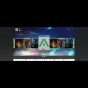 May include: A digital interface displaying a game library. The screen shows game covers with various graphics and titles. An application window with a green 'A' logo is centered. The interface is labeled "Aurora" at the bottom.