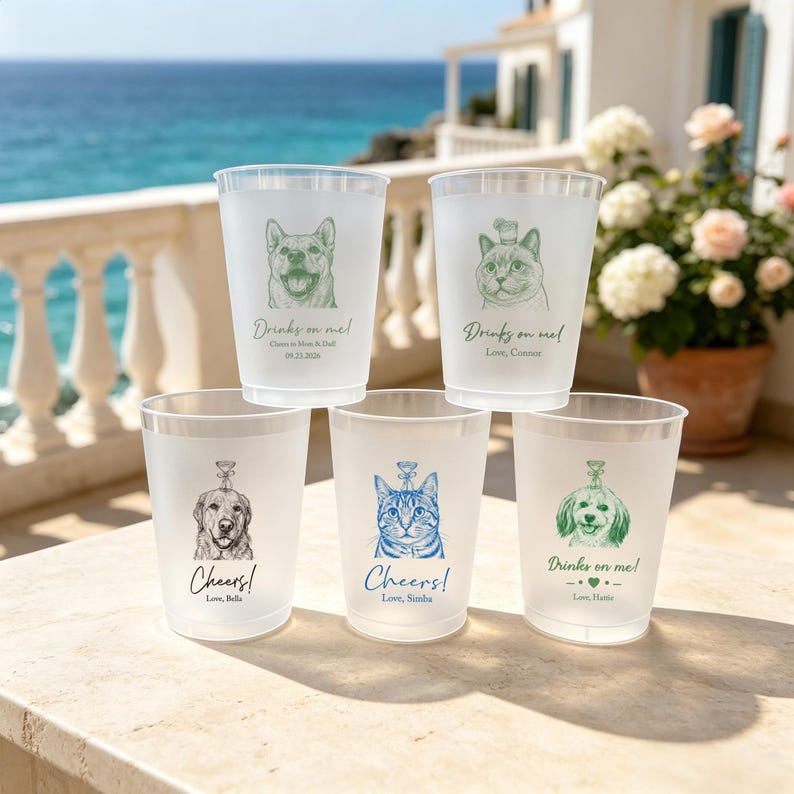 May include: Five frosted plastic cups featuring custom illustrations of dogs and cats. Each cup displays a unique pet portrait in green, blue, or black ink, accompanied by text such as Drinks on me!, Cheers!, and personalized names and dates.