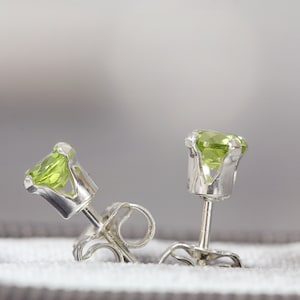 Simple, minimal round stud earrings made with aquamarine gemstones set into sterling silver ear posts. Available in various sizes including 3 milimetres diameter, 4 milimetres diameter, 5 milimetres diameter and 6 milimetres diameter.