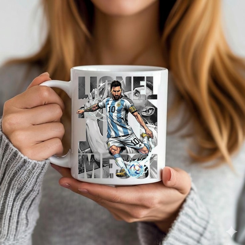 May include: White ceramic mug featuring a graphic of a soccer player in a blue and white striped jersey, kicking a soccer ball. The mug has the name "Lionel Messi" printed in a stylized font.