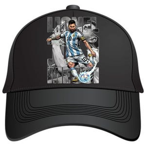 May include: Black baseball cap featuring a graphic of a soccer player in a blue and white striped jersey kicking a soccer ball. The player's name and the word "Messi" are visible on the cap.