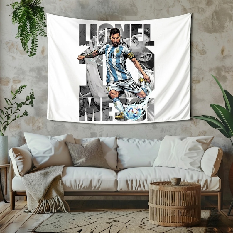 May include: White wall tapestry featuring a graphic of a soccer player in a blue and white striped jersey kicking a soccer ball. The player's name, "Lionel Messi," is printed in large letters. The tapestry is hanging on a textured wall.