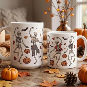 May include: Two white ceramic mugs featuring a repeating pattern of dancing skeletons, jack-o'-lanterns, bats, and autumn leaves. The skeletons are depicted in various poses, some wearing tattered clothing and carrying small pumpkin buckets.