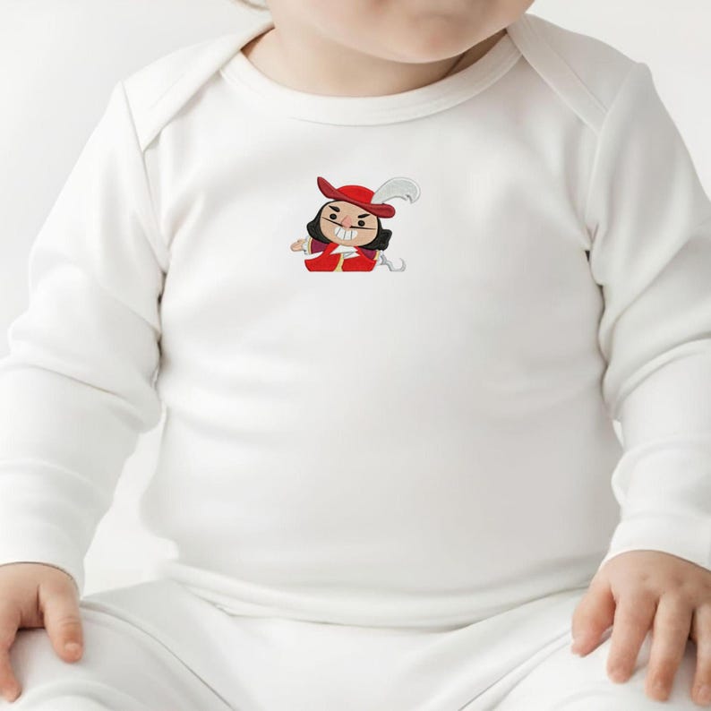 May include: White long-sleeve baby bodysuit with a cartoon graphic of a character in a red hat and coat. The character has black hair and a stern expression. The bodysuit is made of soft material.