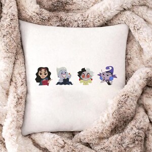 May include: White square pillow featuring four cartoon character designs. The characters are in a row and include a woman with dark hair, a woman with white hair, a character with black and white hair, and a purple character.
