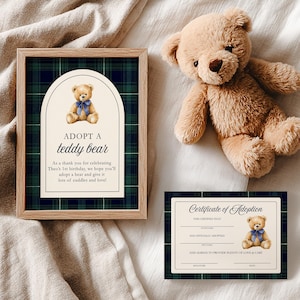 May include: A plush brown teddy bear with a blue ribbon, a framed print that says "ADOPT A teddy bear", and a certificate of adoption. The print has a plaid background and the text "As a thank you for celebrating Theo's 1st birthday, we hope you'll adopt a bear and give it lots of cuddles and love!"