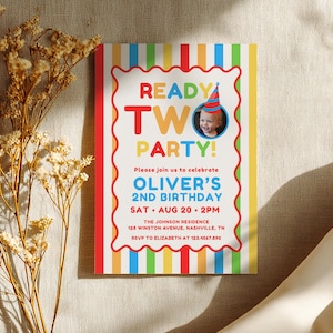 May include: A colorful birthday party invitation with the text "READY TWO PARTY!" and a photo of a child wearing a party hat. The invitation includes the details for Oliver's 2nd birthday, including the date, time, and location.