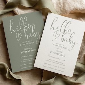 May include: Two baby shower invitations. One is sage green, the other is off-white. Both feature the words "hello baby" in cursive with a heart. Details include the name Jessica Fitzpatrick, date, time, and RSVP information.