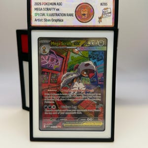 May include: A graded Mega Scrafty ex Pokémon card in a black case. The card features a colorful illustration of a Mega Scrafty character. The card is labeled "Special Illustration Rare" and includes the artist's name, "5ban Graphics."