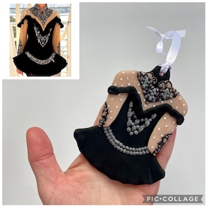 May include: A black and beige ornament shaped like an Irish dance dress, with silver and clear embellishments. The ornament has a white ribbon for hanging. The image also includes a photo of the dress.