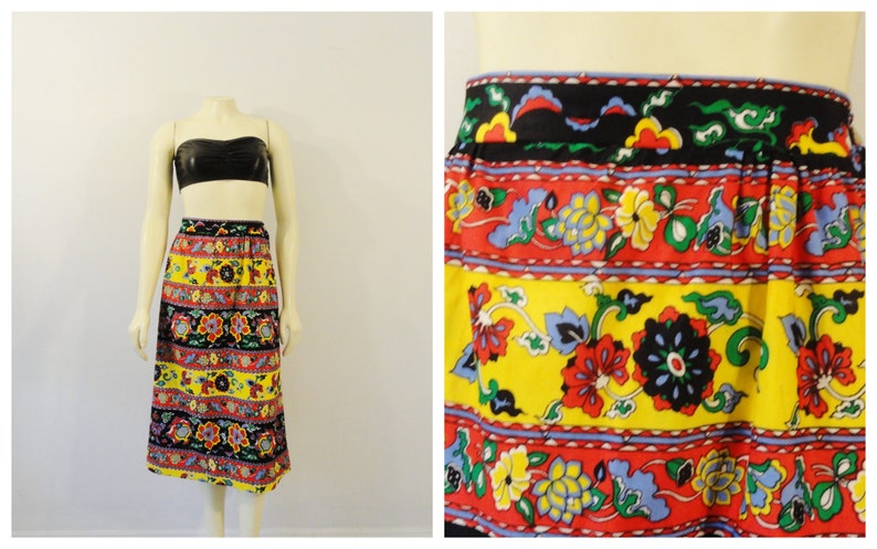 Puede incluir: Una falda midi de estampado floral amarillo, rojo, azul y negro con una cintura el&aacute;stica ancha.