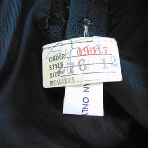 May include: A white tag with black text that reads "Order", "Style", "Size", and "Remarks". The tag has handwritten numbers on it: "09017", "276", and "12".