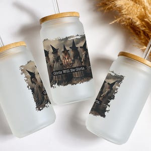 May include: Three frosted glass tumblers with bamboo lids and clear glass straws. Each tumbler features a graphic print of witches in pointed hats standing in a circle with the text Girls Will Be Girls printed in a black rectangular banner.