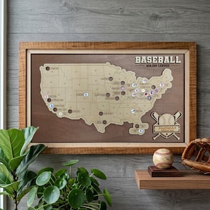 May include: A wooden baseball stadium map of the United States with team logos and the text "BASEBALL MAJOR LEAGUE". The map is framed in a brown wooden frame. A baseball and glove are on a wooden shelf.