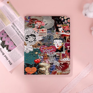 May include: A colorful collage design on a tablet case. The design includes images of Betty Boop, hearts, cherries, and the text "You Are Entering the Land of Love". The case is on a pink surface.