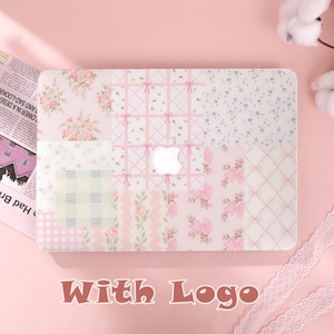 May include: A laptop hard shell case featuring a patchwork design of various patterns including pink roses, blue floral prints, pink bows on a grid, and checkered squares. The center of the case has a cutout revealing the white Apple logo.