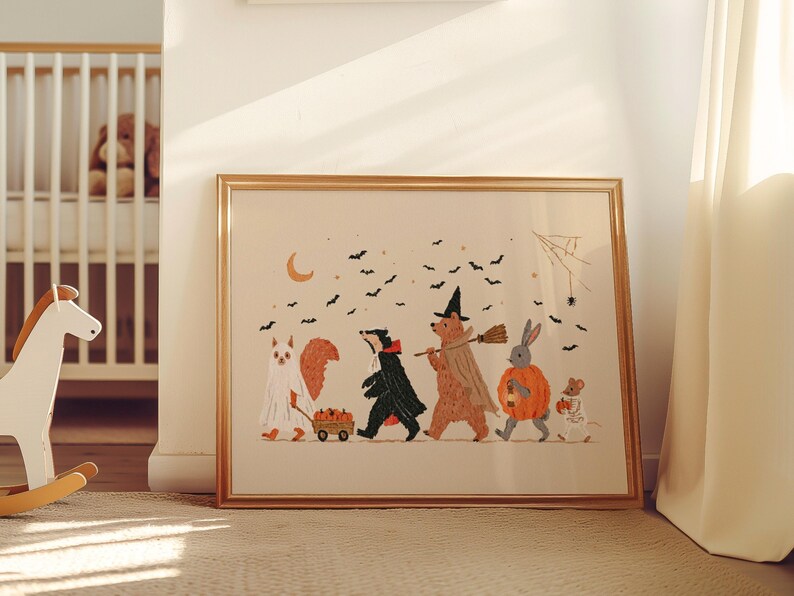 May include: A framed horizontal art print featuring a group of woodland animals dressed in Halloween costumes, including a ghost, a vampire, a witch, a pumpkin, and a skeleton, walking under a crescent moon and black bats.