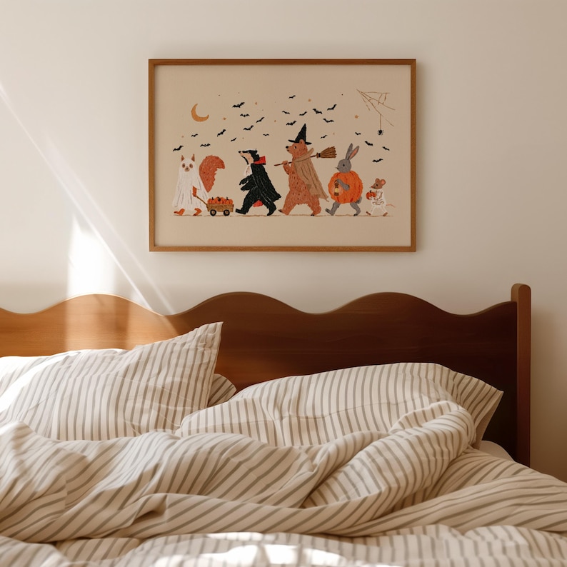 May include: A framed horizontal art print featuring a whimsical Halloween illustration of a squirrel in a ghost costume, a badger in a cape, a bear as a witch, a rabbit in a pumpkin, and a mouse, all walking under a crescent moon and bats.