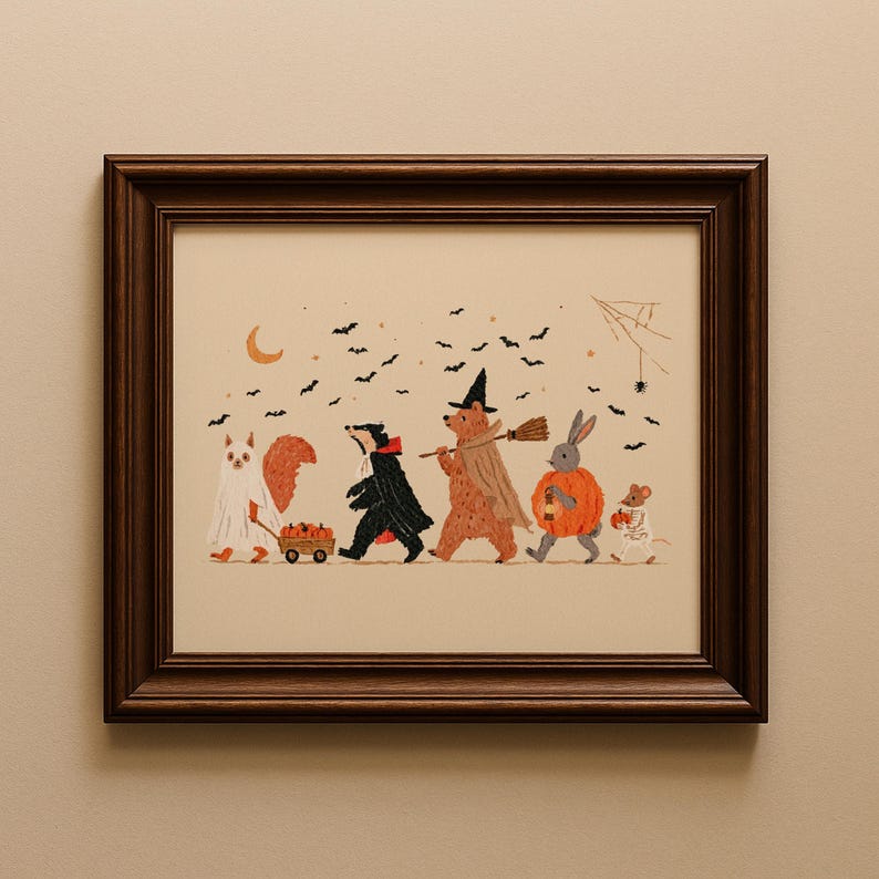 May include: A framed illustration featuring a squirrel in a ghost costume pulling a wagon of pumpkins, a badger in a black cape, a bear in a witch hat with a broom, a rabbit in a pumpkin suit, and a mouse in a skeleton costume under bats.