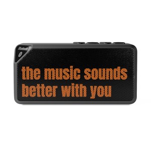 May include: A black rectangular Bluetooth speaker with the orange text "the music sounds better with you". The speaker has a mesh front and control buttons on top. The Bluetooth logo is visible.
