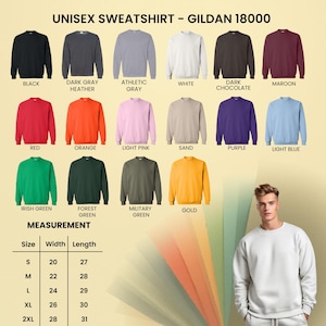 May include: A product image showcasing a variety of Gildan 18000 unisex sweatshirts in various colors, including black, gray, red, orange, and green. The image also displays a measurement chart with sizes ranging from S to 2XL, with width and length measurements in inches.