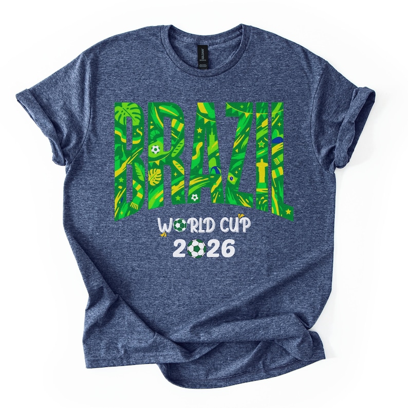 May include: A blue t-shirt with the word "BRAZIL" in large green and yellow letters, filled with tropical patterns. Below, the text reads "WORLD CUP 2026" with soccer ball graphics.