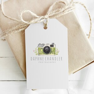 May include: A white gift tag with a green and white camera illustration and the text "Daphne Chandler Photography".