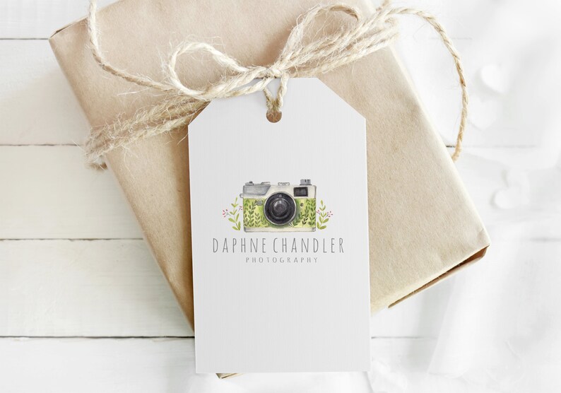 May include: A white gift tag with a green and white camera illustration and the text "Daphne Chandler Photography".