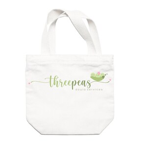 May include: White tote bag with green text that reads "threepeas doula services" and a green pea pod with three peas and a pink flower.
