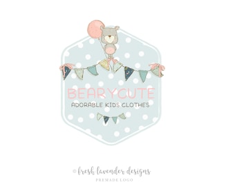 May include: A light blue hexagon with white polka dots features a cartoon bear holding a pink balloon. The bear is sitting on a string of colorful flags that reads "BEARYCUTE ADORABLE KIDS CLOTHES".