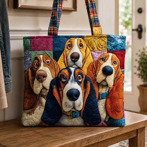 May include: A quilted tote bag featuring a colourful patchwork design with four Basset Hound dogs. The dogs have long ears, expressive eyes, and are wearing collars. The bag has two fabric handles with a multi-coloured plaid pattern.