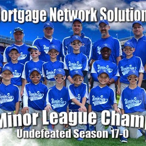 May include: A group of young baseball players in blue uniforms pose with their coaches in front of a baseball stadium. The team is called "Wamin Rue" and they are the 2017 Minor League Champions, with an undefeated season of 17-0. The team is sponsored by Mortgage Network Solutions.