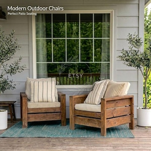 May include: Two wooden outdoor chairs with beige cushions and striped pillows are on a teal rug. The chairs are in front of a window with a view of trees. The text "Modern Outdoor Chairs" and "Perfect Patio Seating" is at the top.
