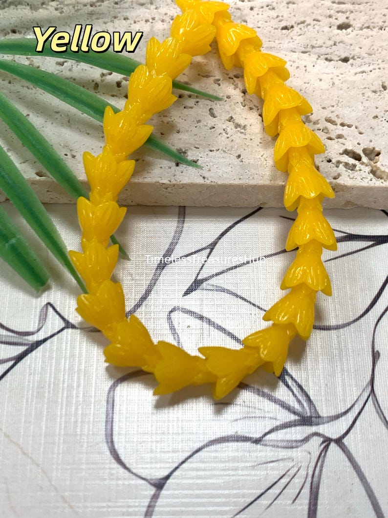 May include: A bright yellow beaded bracelet featuring a series of small, molded flower-shaped beads linked together in a continuous circular strand. The text "Yellow" appears in the upper left corner, and "TimelessTreasuresHub" is printed in the center.