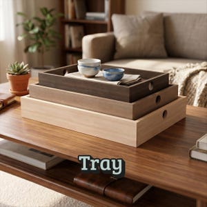 May include: A set of three rectangular wooden trays stacked on top of each other, featuring a light wood, medium brown, and dark brown finish. Each tray has circular cutout handles on the sides. Two small ceramic bowls sit on the top tray.