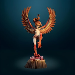 May include: A detailed figurine of a harpy with a human upper body and bird-like lower body, featuring large orange and yellow wings, flowing hair, and sharp talons. The creature stands on a textured, rocky base with pinkish accents at the bottom.