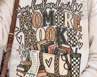 May include: A cream-colored sweatshirt featuring the text "my husband said NO MORE BOOKS" in a mix of leopard print, polka dot, and checkered patterns. Below the text is an illustration of a tote bag filled with books, a receipt, and a tumbler.
