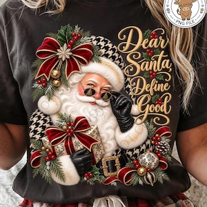 May include: A black t-shirt featuring a graphic of Santa Claus wearing black-rimmed glasses, a houndstooth hat, and black gloves. Santa holds a gift wrapped in gold paper with a red bow. The text reads Dear Santa Define Good in gold script.