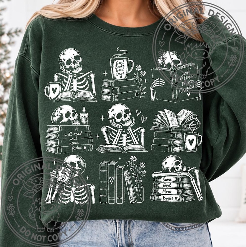 May include: A dark green crewneck sweatshirt featuring a white graphic print of nine distinct scenes with skeletons reading books, drinking from mugs, and flowers. The text includes Good Books Good Days, A well-read soul never fades, and Same Girl More Books.
