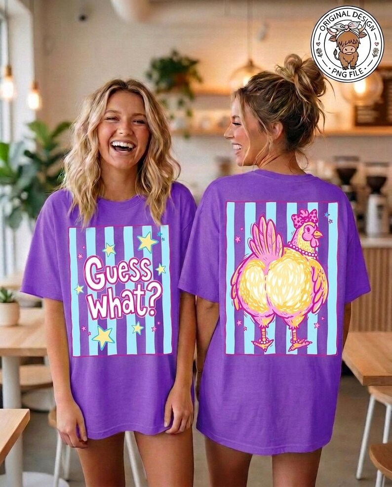May include: Two women wearing purple t-shirts. The front of the shirt has the text "Guess What?" with stars and stripes. The back of the shirt features a cartoon chicken with a bow and necklace, set against a striped background.