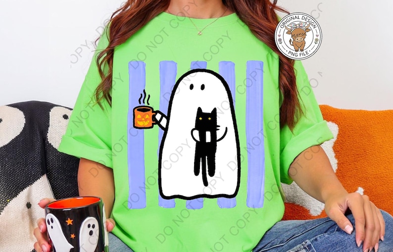 May include: A bright lime green t-shirt featuring a graphic of a white ghost holding an orange jack-o'-lantern mug and a black cat. The design is set against vertical light purple stripes. The shirt is worn with blue denim jeans.