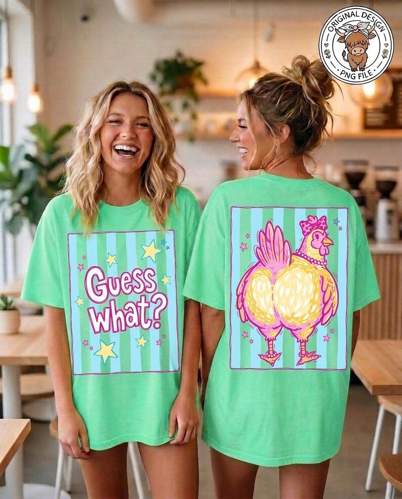 May include: Two women wearing matching green t-shirts. The front of the shirt has the text "Guess What?" inside a blue and green striped box with stars. The back of the shirt features a cartoon chicken design.