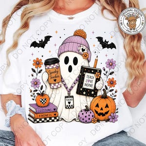 May include: A white t-shirt featuring a graphic of a ghost wearing a purple beanie, holding a coffee cup labeled Spooky Teacher and a book labeled Teach Love Inspire. The design includes bats, pumpkins, flowers, and a stack of books labeled Lessons and Kindness.