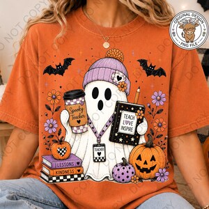 May include: An orange t-shirt featuring a graphic of a ghost wearing a purple beanie, holding a coffee cup labeled Spooky Teacher and a book labeled Teach Love Inspire. The ghost wears a teacher lanyard and stands by pumpkins and books.
