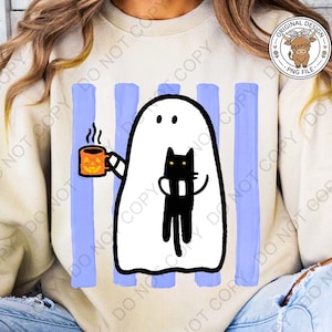 May include: A beige crewneck sweatshirt featuring a graphic print of a white ghost holding an orange mug with a jack-o'-lantern face and hugging a black cat. The design is set against a background of vertical light blue brushstroke stripes.